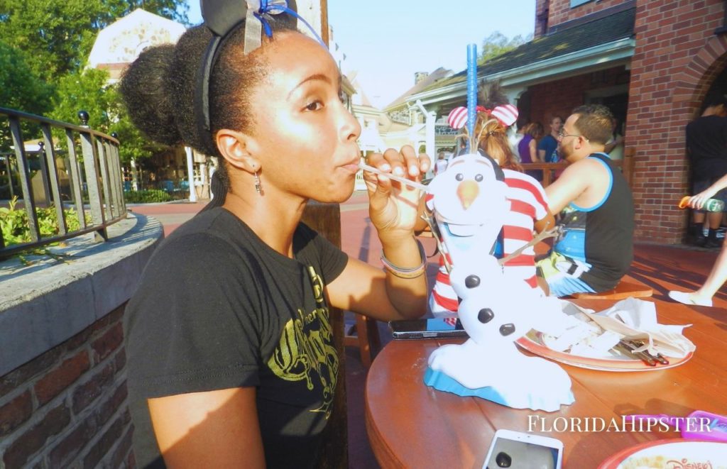 NikkyJ enjoying a snack at Disney World. Keep reading to learn more about things to do in Orlando for your birthday.