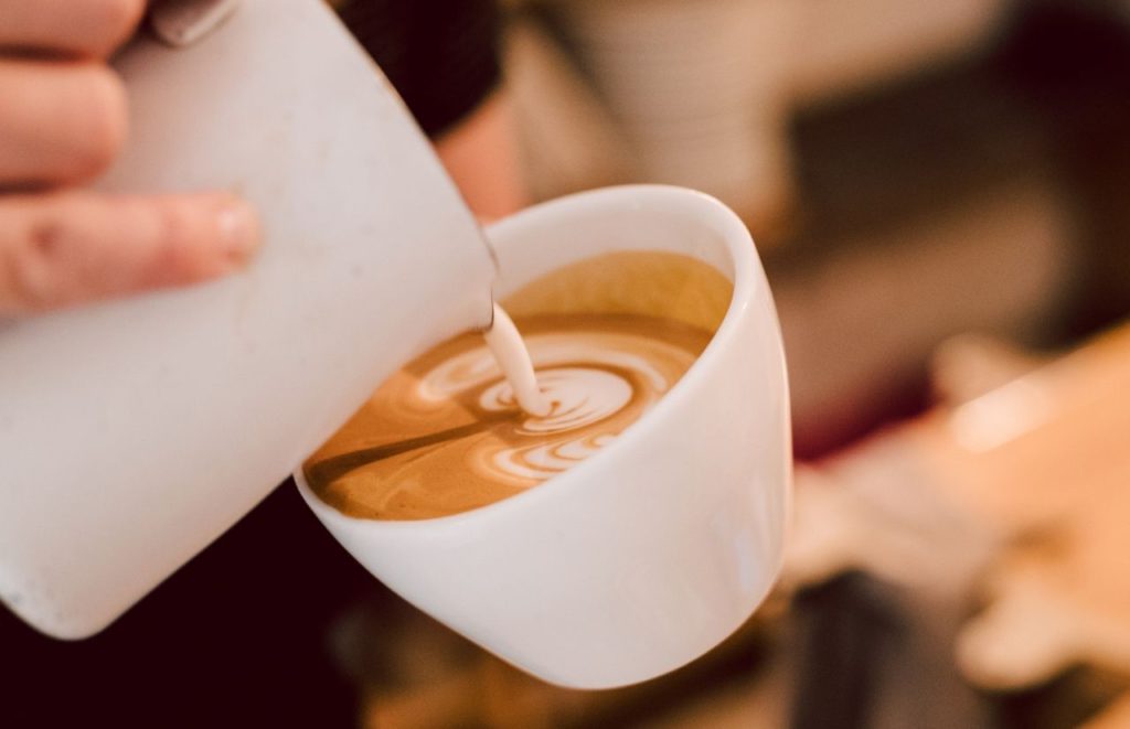 Latte being poured, Afternoon Restaurant in Gainesville Florida. Keep reading to find out the best places for brunch in Gainesville. 