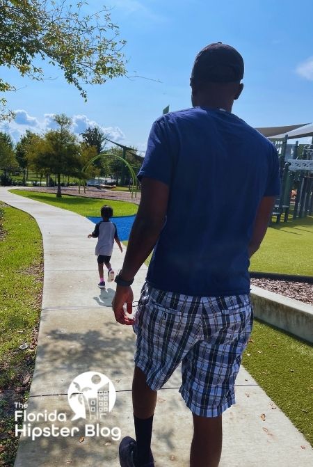 Black dad and daughter at Depot Park Gainesville Florida. Keep reading to discover more of the best Gainesville trails and parks.. 