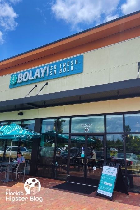  Outdoor exterior of Bolay Gainesville Florida with umbrella covered patio dining. 