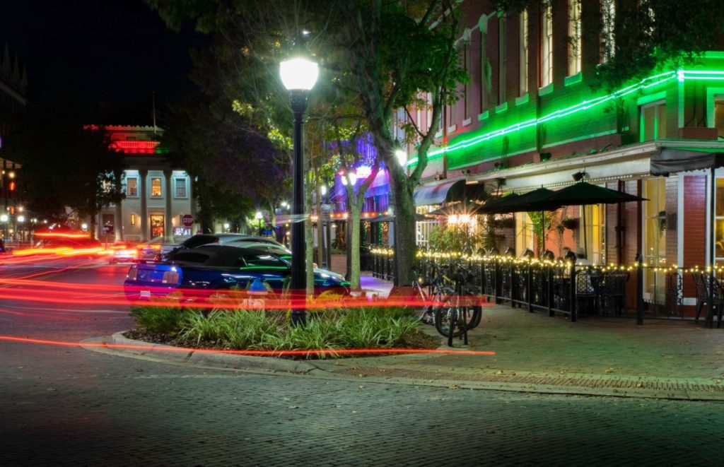 Downtown Gainesville at Night lit up with colored lights on the buildings. Keep reading to find out more about fun things to do in Gainesville that’s free.