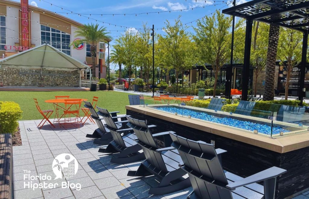 Gainesville Florida Celebration Pointe firepit area and Regal Cinema. Keep reading to find out more about Hotel Indigo Gainesville.