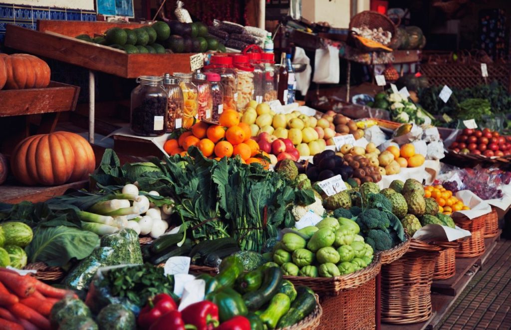 Farmers Market at the beach with rows of vegetables. Keep reading for your full guide to the best Florida beaches in September.