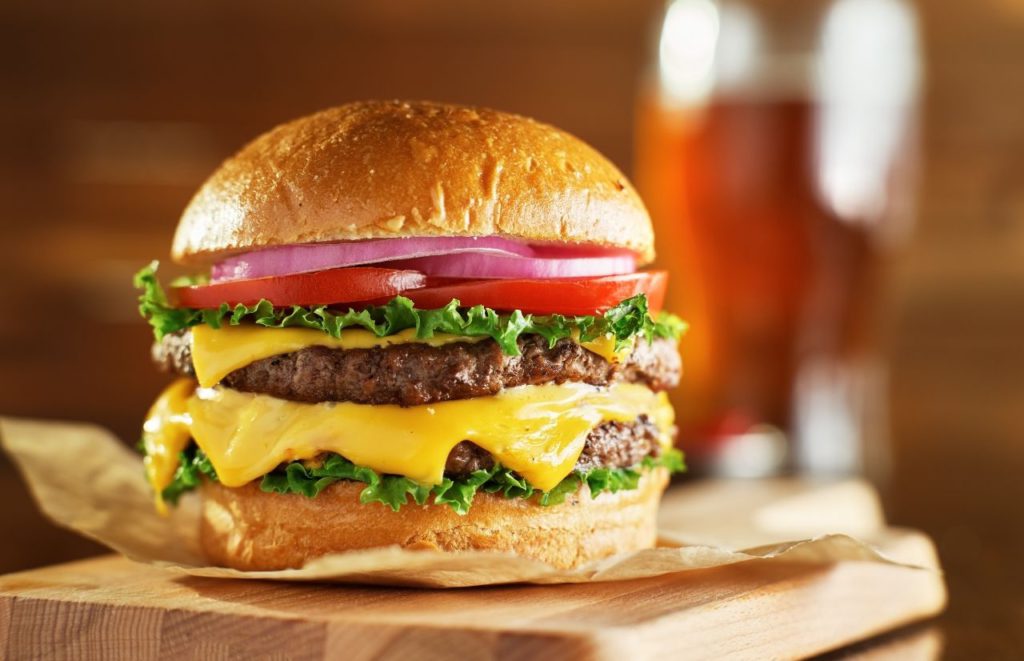 Big burger and beer at Loosey's Gainesville Florida. Keep reading to learn more about Gainesville bars.