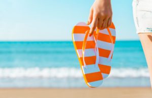 Orange and White Flip Flops on Florida Beach