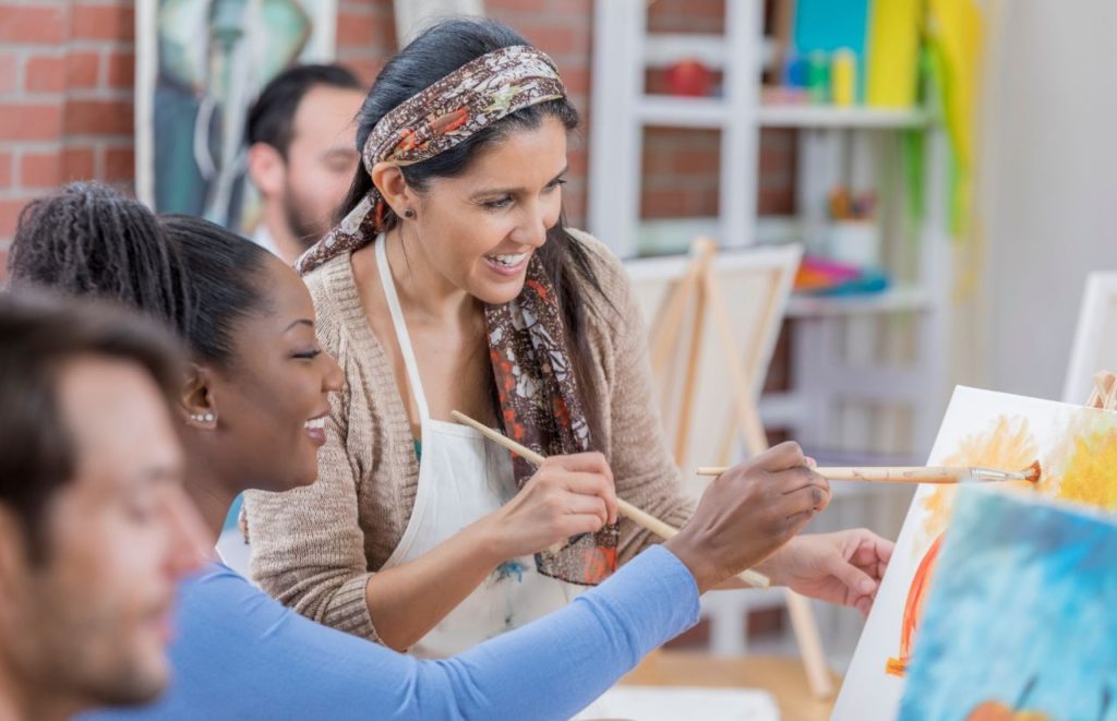 Adults enjoying a painting class. Keep reading to get the full guide on Orlando birthday celebrations.