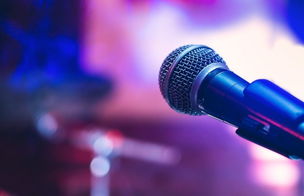 Microphone on stage. Keep reading to learn more about Gainesville bars.