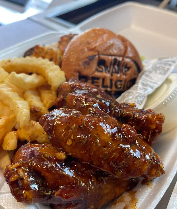 Swamp Religion Food Truck chicken wings, Cajun burger and fries. Keep reading to find out all you need to know about Gainesville food trucks. 