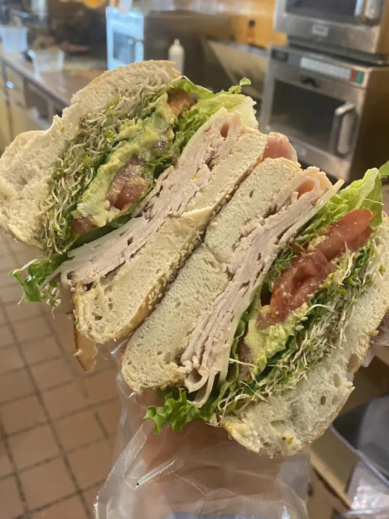 The Bagel Bakery California with Turkey Swiss Cheese Lettuce Tomatoes Avocado and Sprouts. One of the best places to get breakfast in Gainesville, Florida.