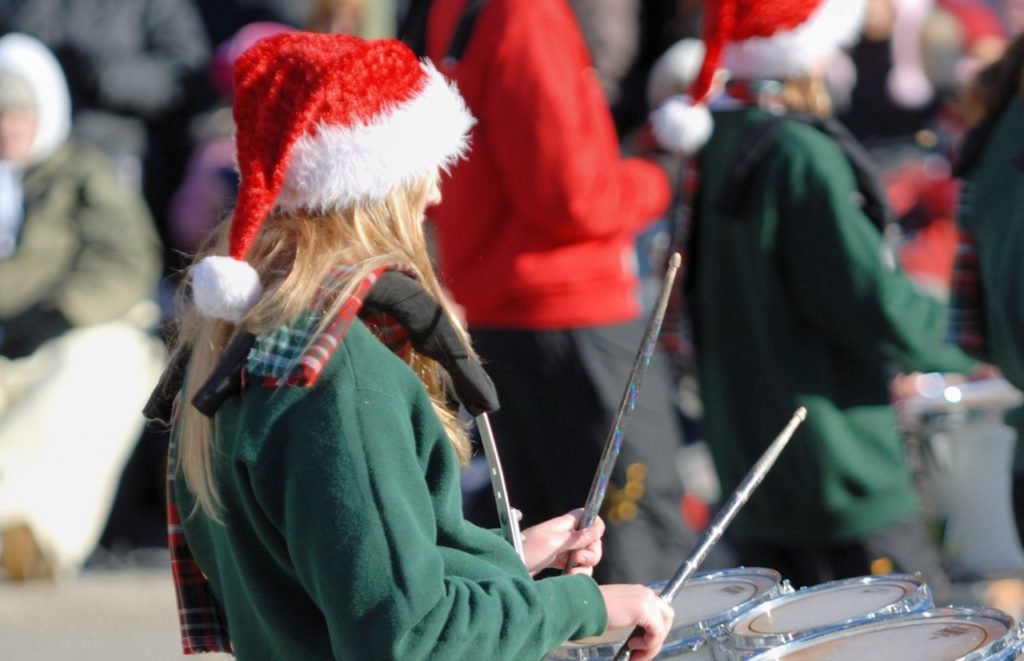 Lady with Green Sweater on with drum set in one of the Holiday Parades! One of the things to in Florida at Christmas.