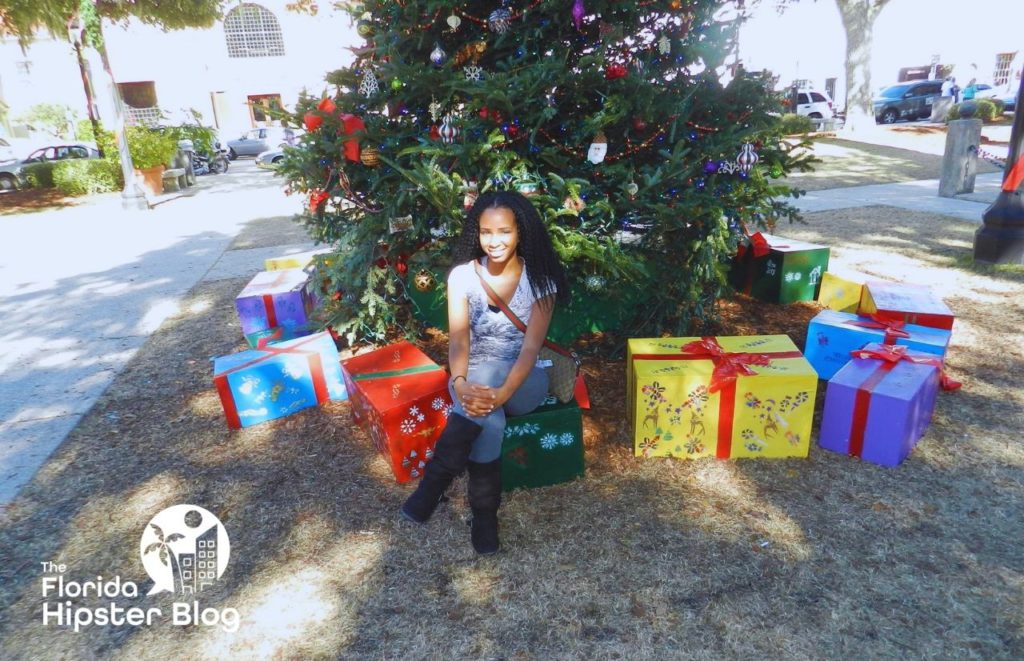 NikkyJ in front on Christmas tree in St Augustine Florida. One of the things to in Florida at Christmas. Keep reading to find out more things to do in Florida at Christmas for 2023. 