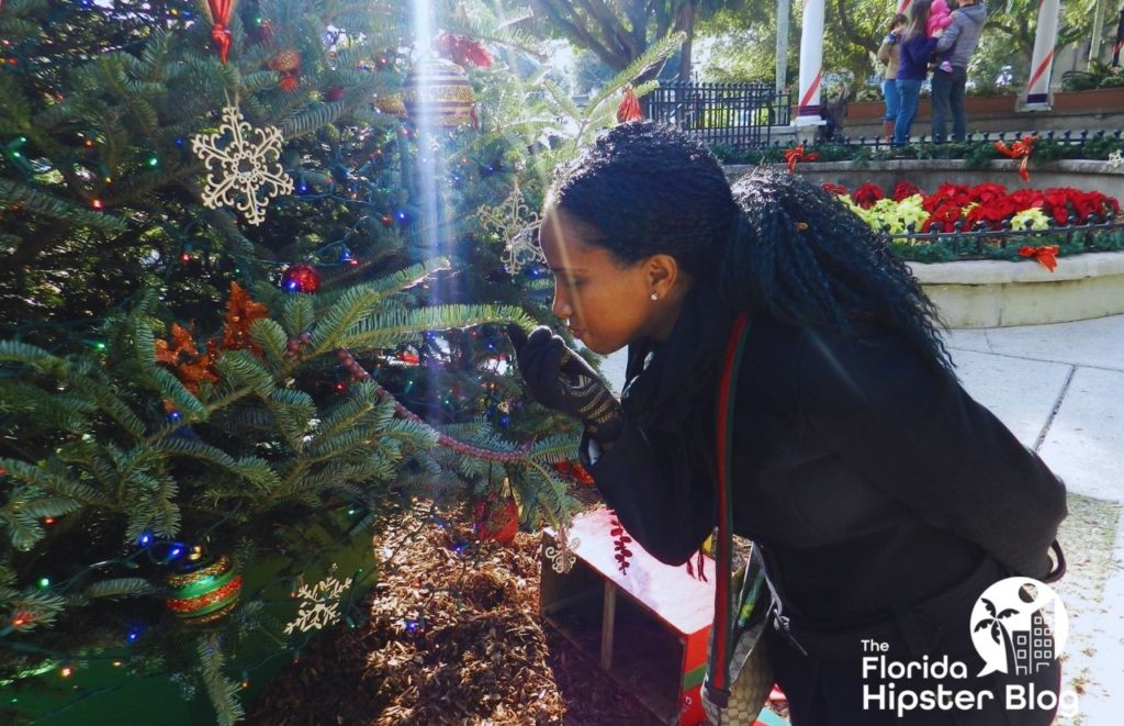 NikkyJ looking at Christmas tree doing holiday tour in St Augustine Florida. Keep reading to learn more about things to do in Florida at Christmas 2023.