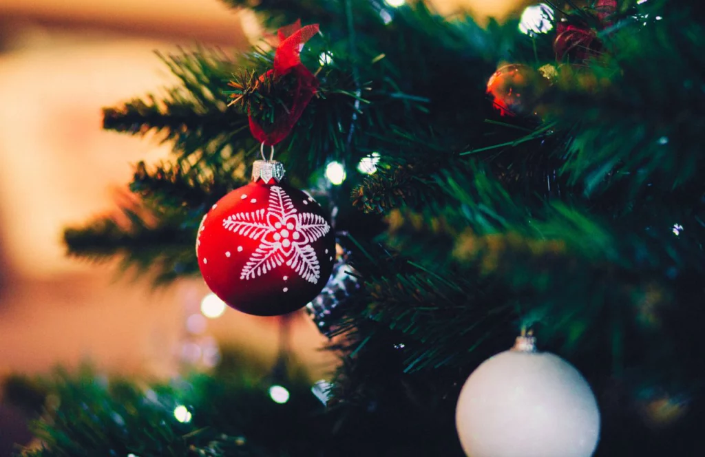 Christmas Tree Up Close with Red Ornament with White Snowflake. Keep reading to find out more of the best Orlando Christmas lights. 