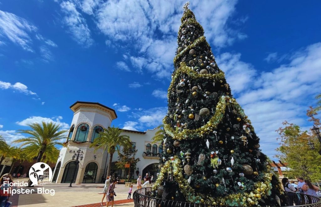 Disney Springs Christmas Tree in front of Zara. Keep reading to get the best Orlando Christmas Lights locations.