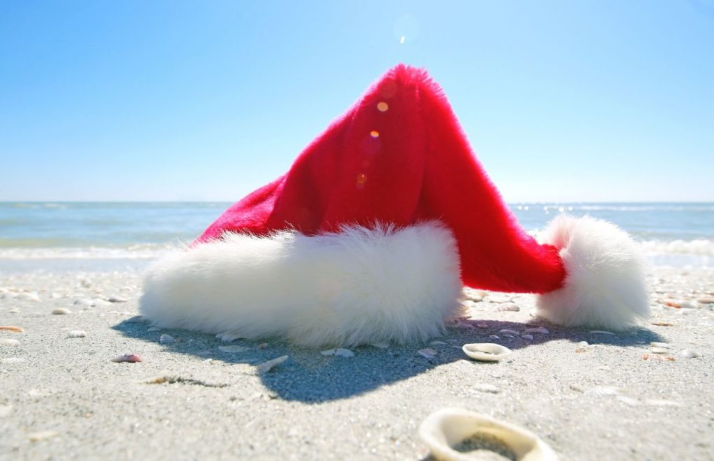 Florida Christmas with Santa Claus hat on the beach of Key West. One of the best things to do in Florida at Christmas. Keep reading to find out more things to do for Christmas in Florida. 