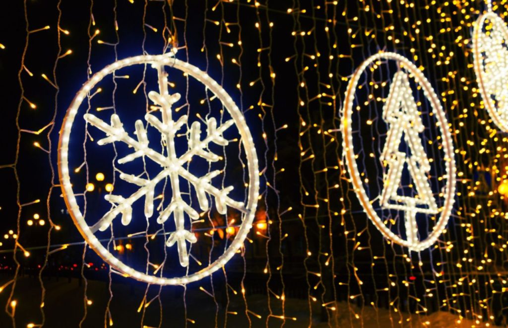 Florida Christmas decorations of hanging snowflake lights amongst cascading Christmas lights. Keep reading to find out more of the best Orlando Christmas lights. 