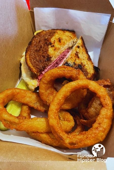 Beaches and Cream Soda Shop Rye Sandwich with Onion rings, Keep reading to find out more about the best ice cream shops in Orlando.