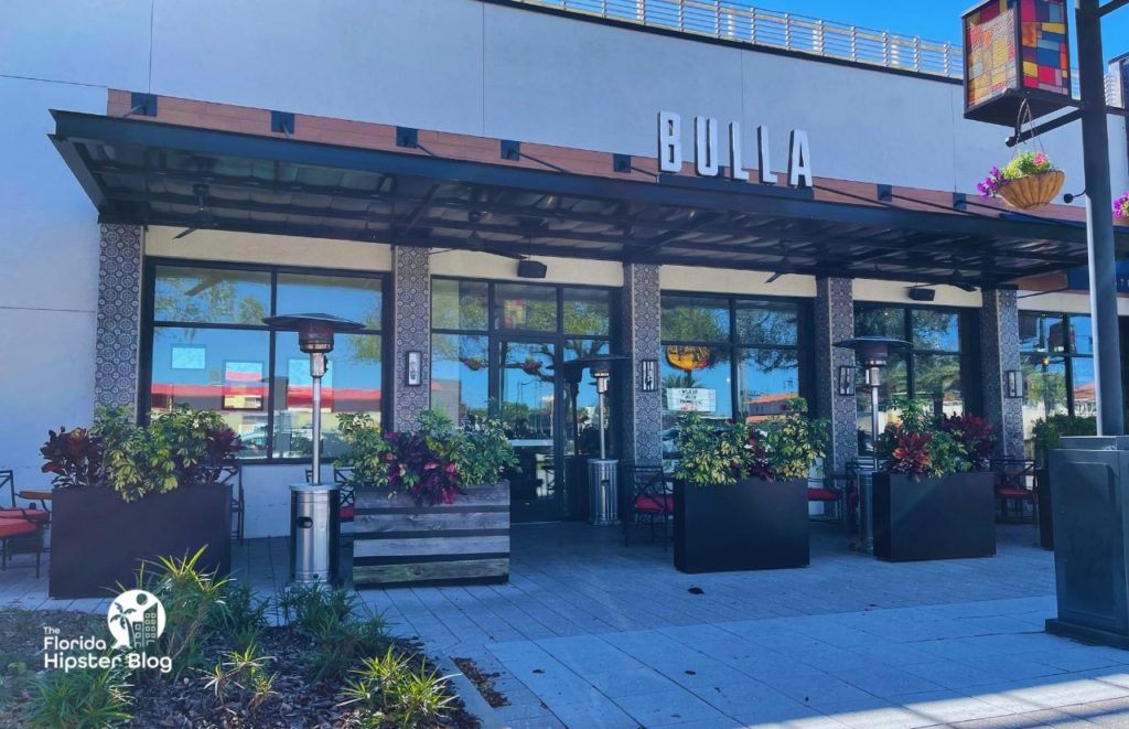 Bulla Restaurant in Winter Park Florida entrance with lots of planters and greenery out front. Keep reading to find out more about the best brunch in Winter Park.