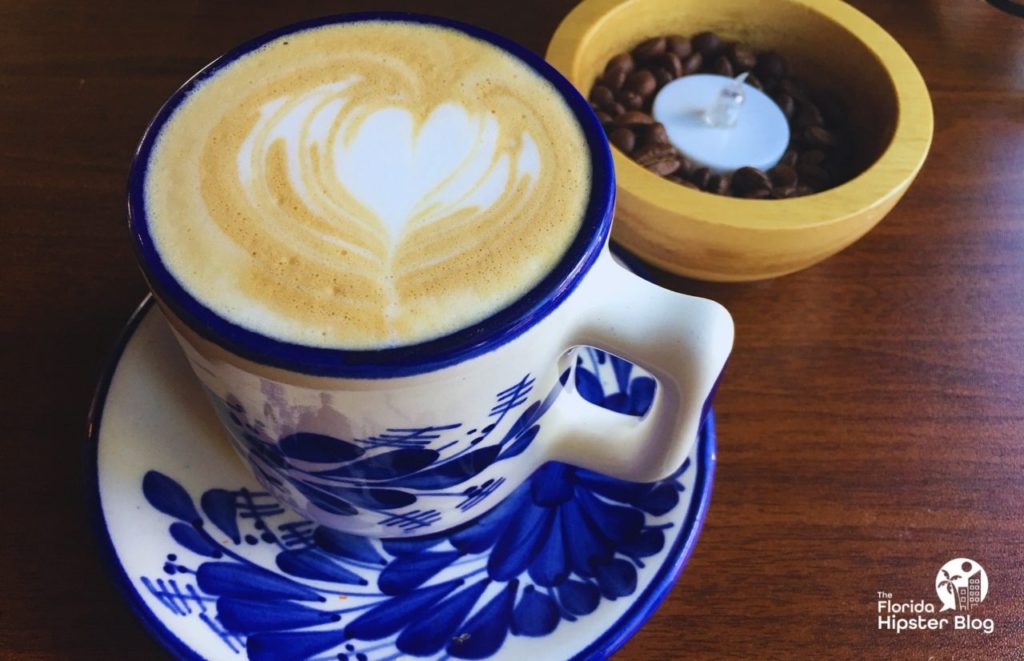 CFS Coffee in Orlando Winter Park Florida Area Latte next to coffee beans. Keep reading to find out where are the best places for brunch in Winter Park.