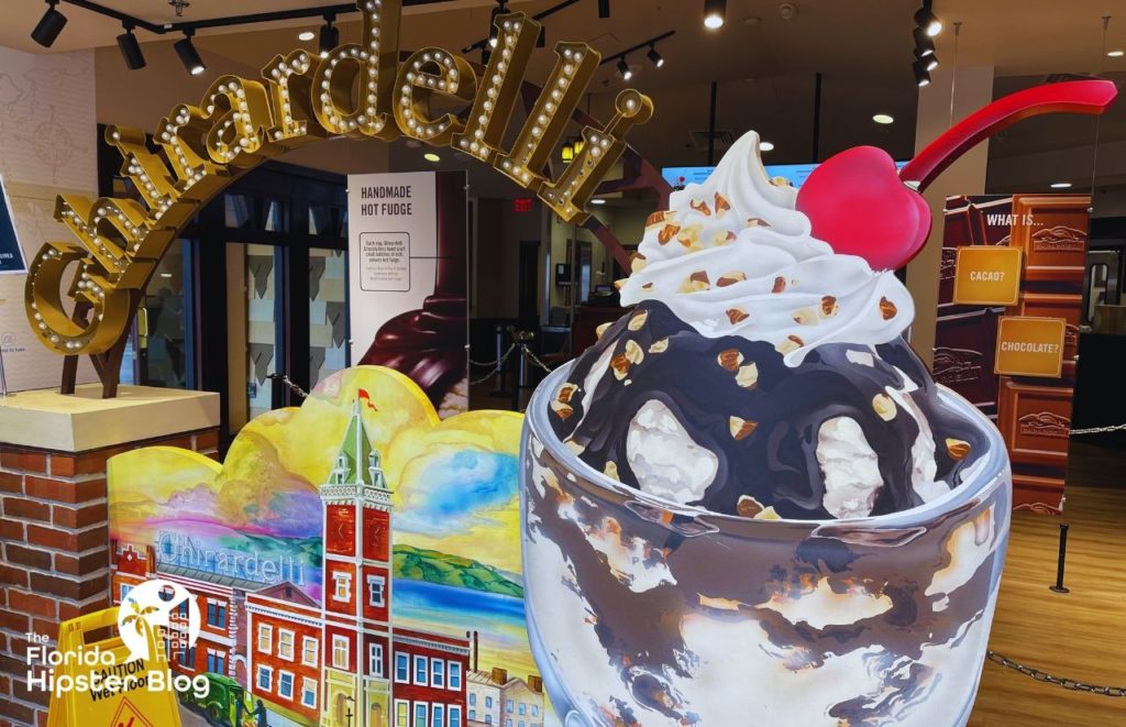 Ghirardelli Ice Cream and Chocolate Shop at Disney Springs with a life size sundae and cherry on top. Keep reading to discover all there is to know about where to celebrate a birthday in Orlando.