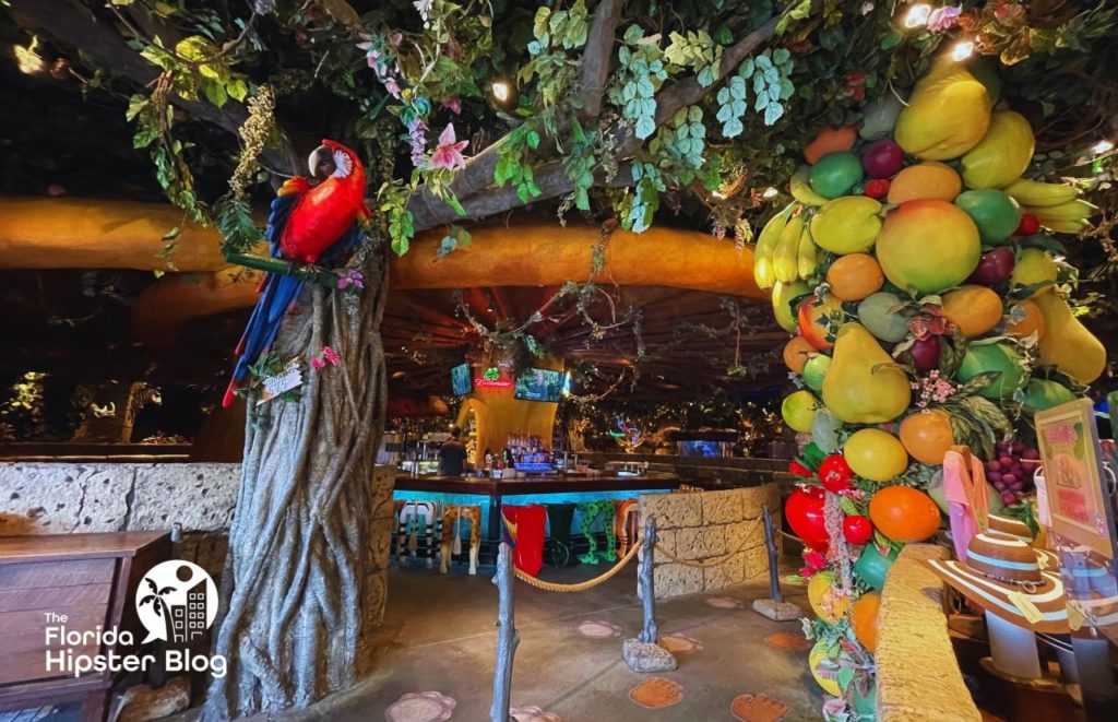 Rainforest Cafe Orlando bar area with tropical fruit and scarlet macaw in the tree. 