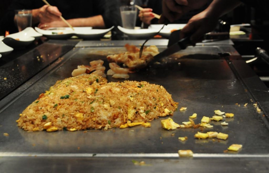 Best hibachi in Orlando at Shogun Japanese Steakhouse with guests eating and watching the cooking performance. Keep reading to find out more about Japanese food in Orlando.