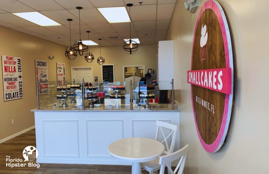 Smallcakes Cupcake and Ice Cream Shop Kissimmee Interior with cupcakes at the counter. Keep reading to learn more about ice cream in Orlando.