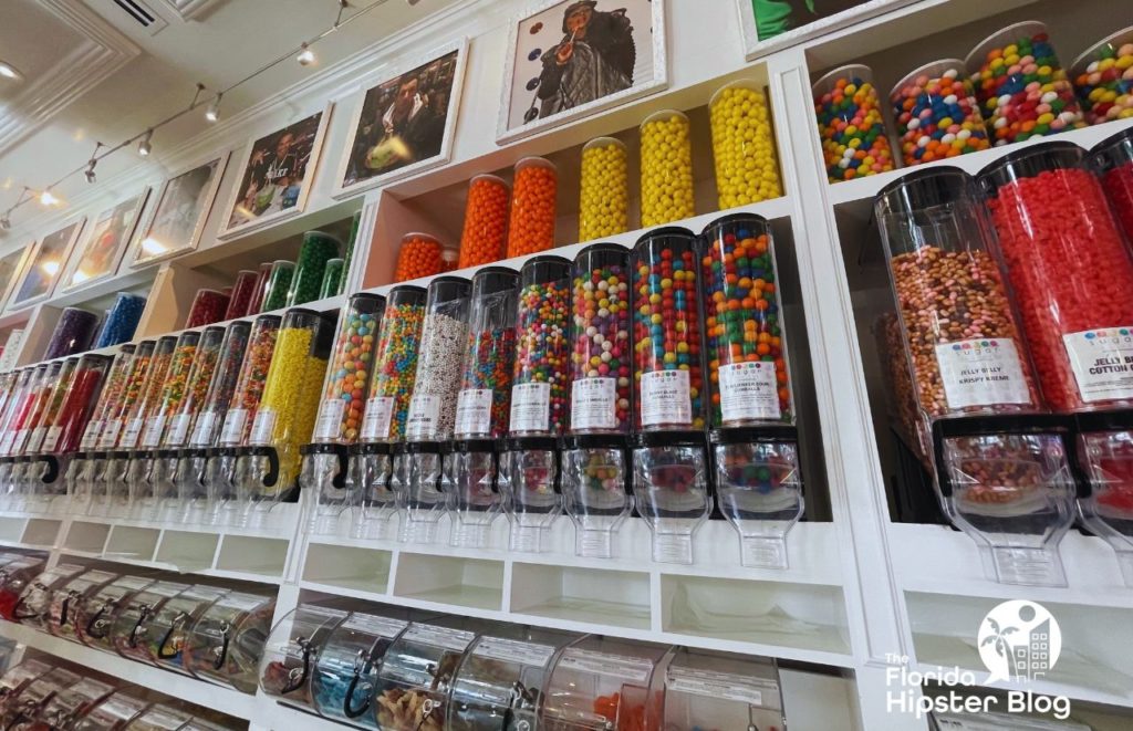 Sugar Factory Candy Wall with Celebrity photos lined above in Orlando Florida. Keep reading to learn more about kid friendly restaurants in Orlando.