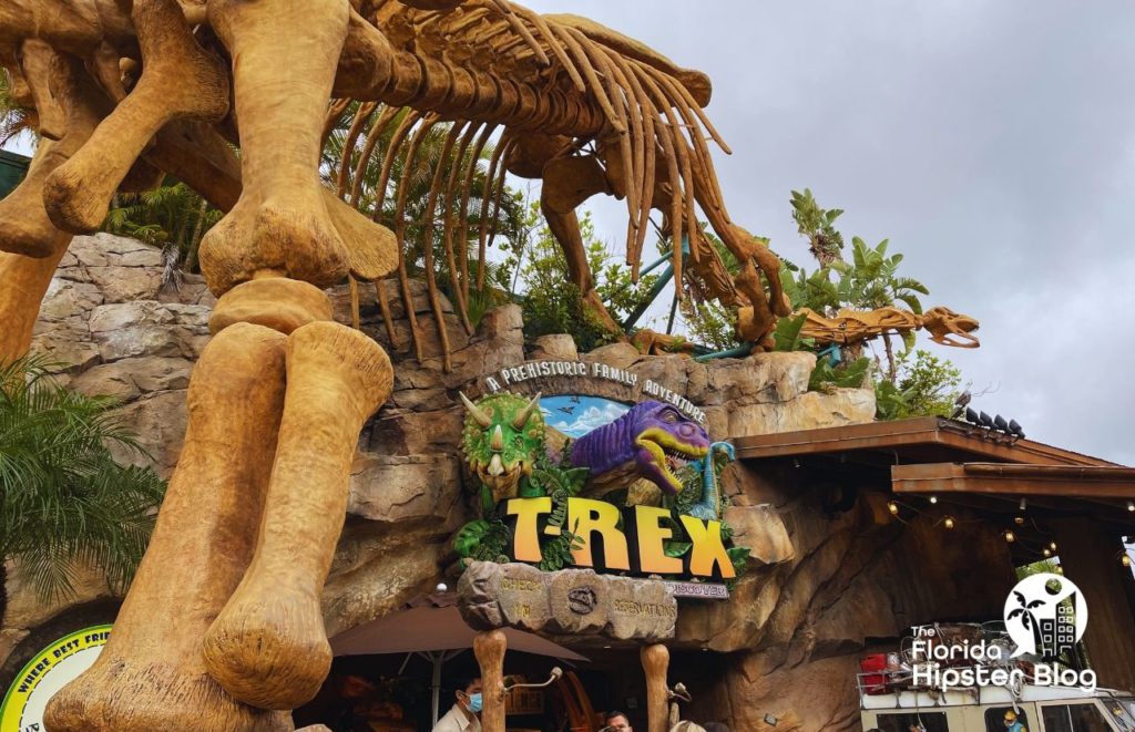 T Rex Cafe view of the outside exterior and entrance with large dinosaur bones. Keep reading to discover the kid friendly restaurants in Orlando.