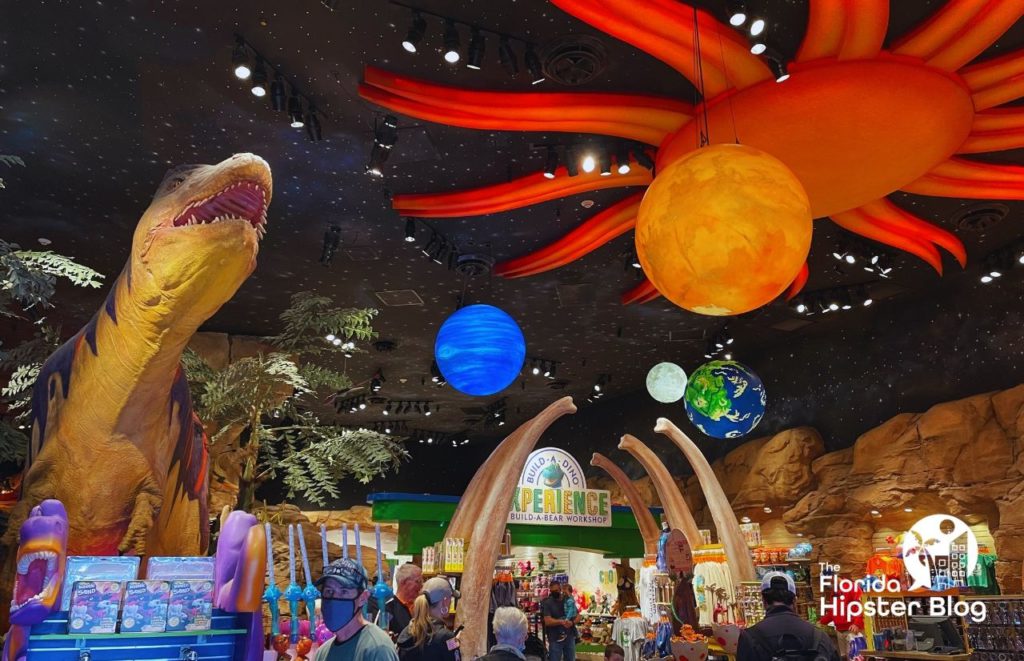 T Rex Cafe at Disney Springs with larger than life dinosaur and merchandise. Keep reading to learn more about kid friendly restaurants in Orlando.