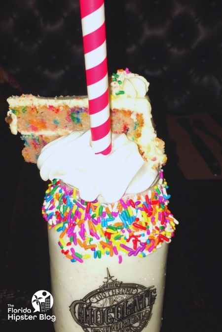 Toothsome Chocolate Emporium Milkshake with Cake on Top Universal Orlando Resort. Keep reading to learn the best dessert in Orlando. 