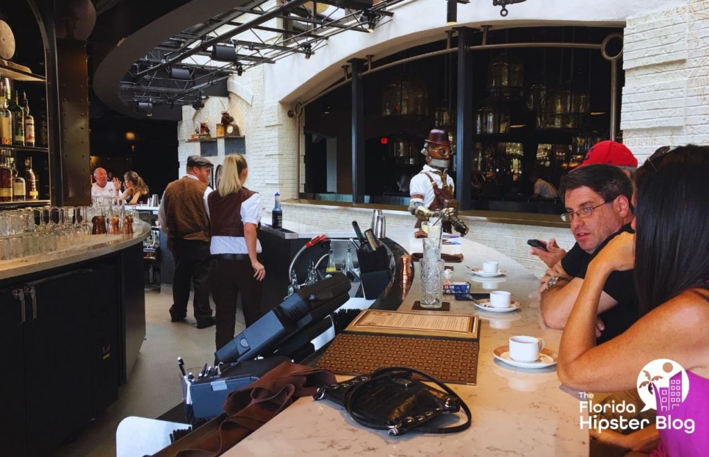 Penelope’s Assistant walking around the bar at Toothsome Chocolate Emporium. Keep reading to find out all you need to know about kid friendly restaurants in Orlando. 