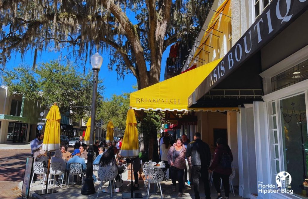 Winter Park Florida Briarpatch Restaurant outdoor seating shaded under the trees. Keep reading to find out all you need to know about brunch in Winter Park.