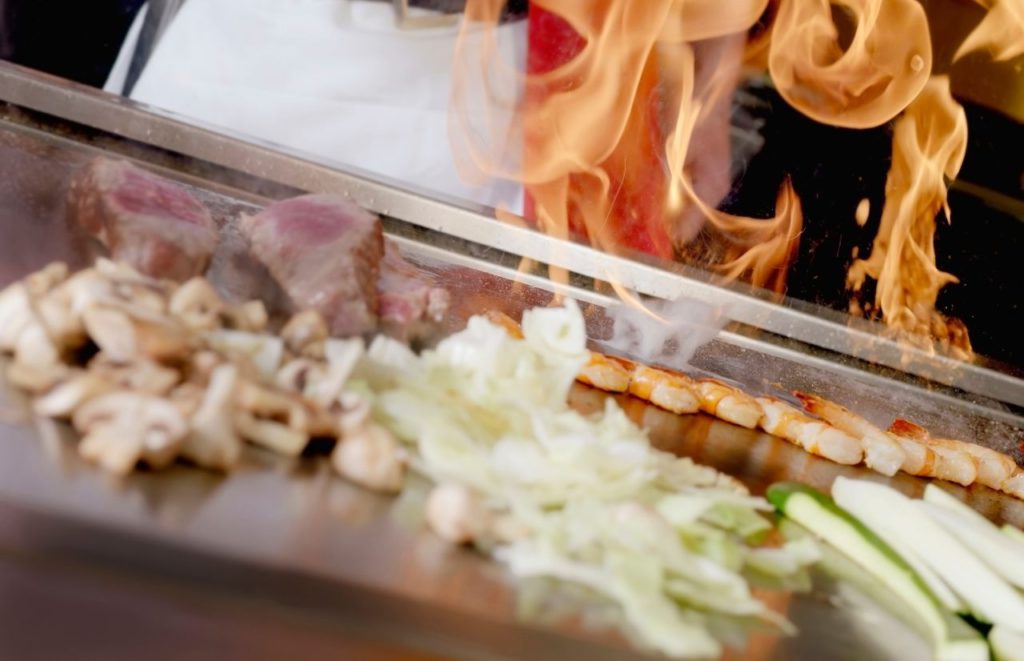 Yamasan Sushi and Grill hibachi with flames. Keep reading to learn more about the best hibachi in Orlando. 