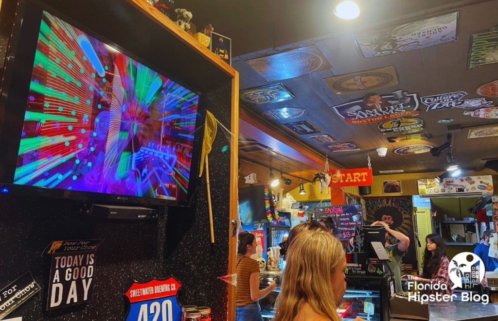 Yellow Dog Eats Interior with large screen tv. Keep reading to find out all you need to know about the best kid restaurants in Orlando. 