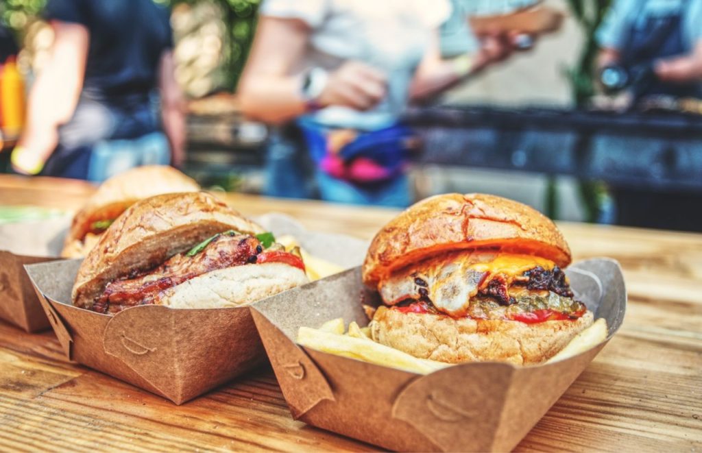 Gainesville burgers in a to go box. Keep reading to discover food trucks in Gainesville.