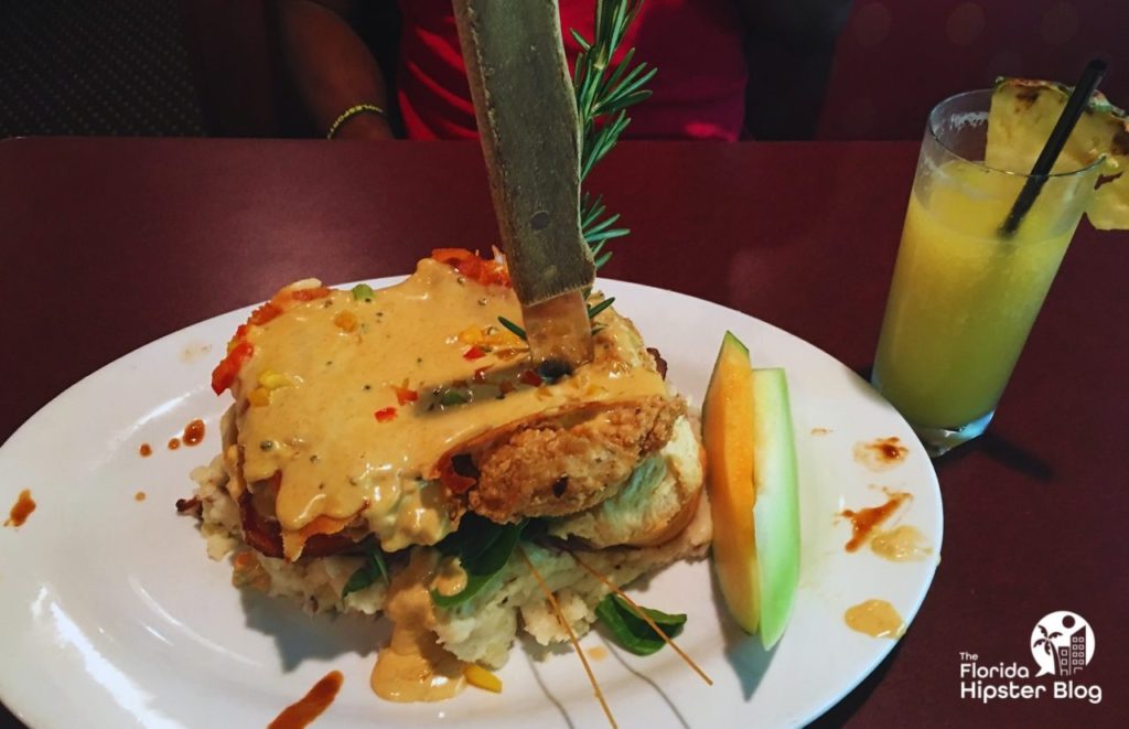 Hash House a Go Go Gigantic Chicken Biscuit with Pineapple Drink. The best breakfast in Orlando, Florida.