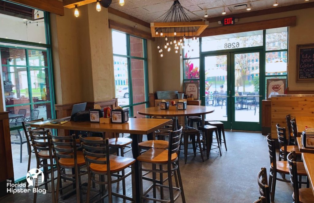 Tables and chairs inside Maple Street Biscuit Company in Kissimmee, Florida. Keep reading for more places to get the best breakfast in Kissimmee, Florida. 