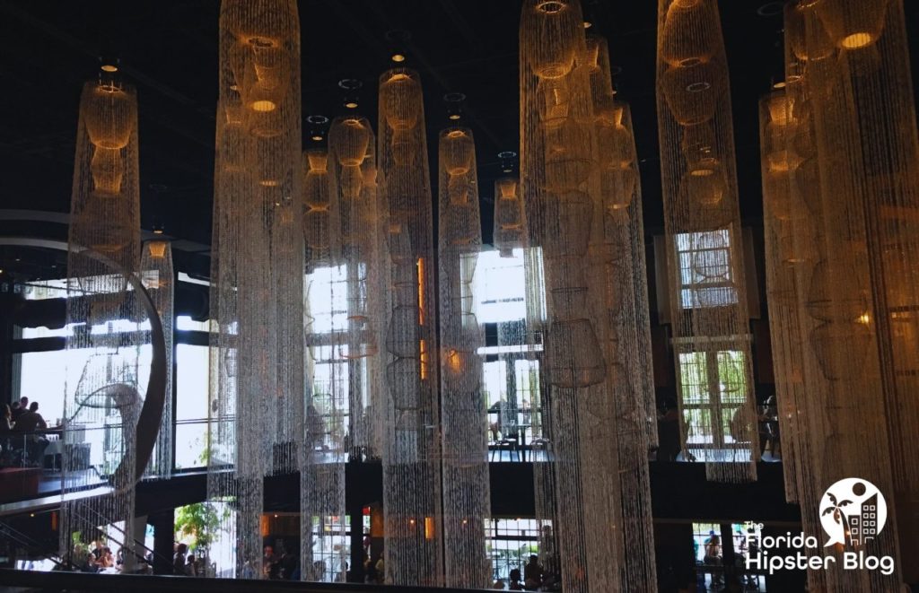 Morimoto Asia in Orlando interior design with long chandeliers. Keep reading to find out all you need to know about sushi in Orlando. 