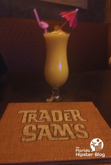 Trader Sams Dole Whip Cocktail at  Walt Disney World. Keep reading to learn more about things to do in Orlando tonight.
