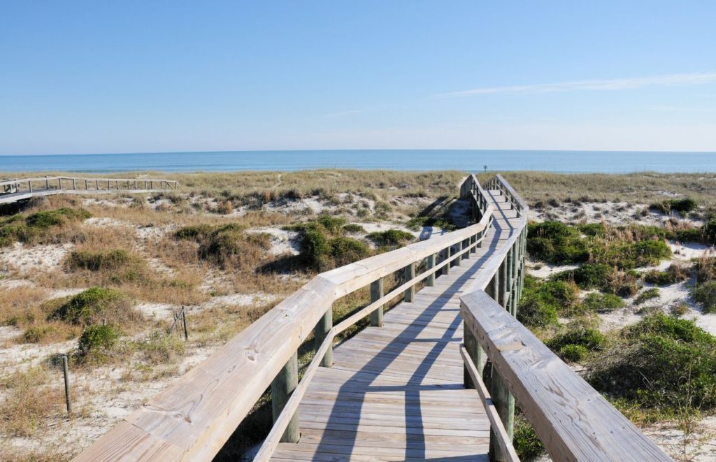 A boardwalk climbs over the sand dunes at Amelia Island, Florida. Keep reading for more places to take a perfect day trip from Orlando, Florida. 