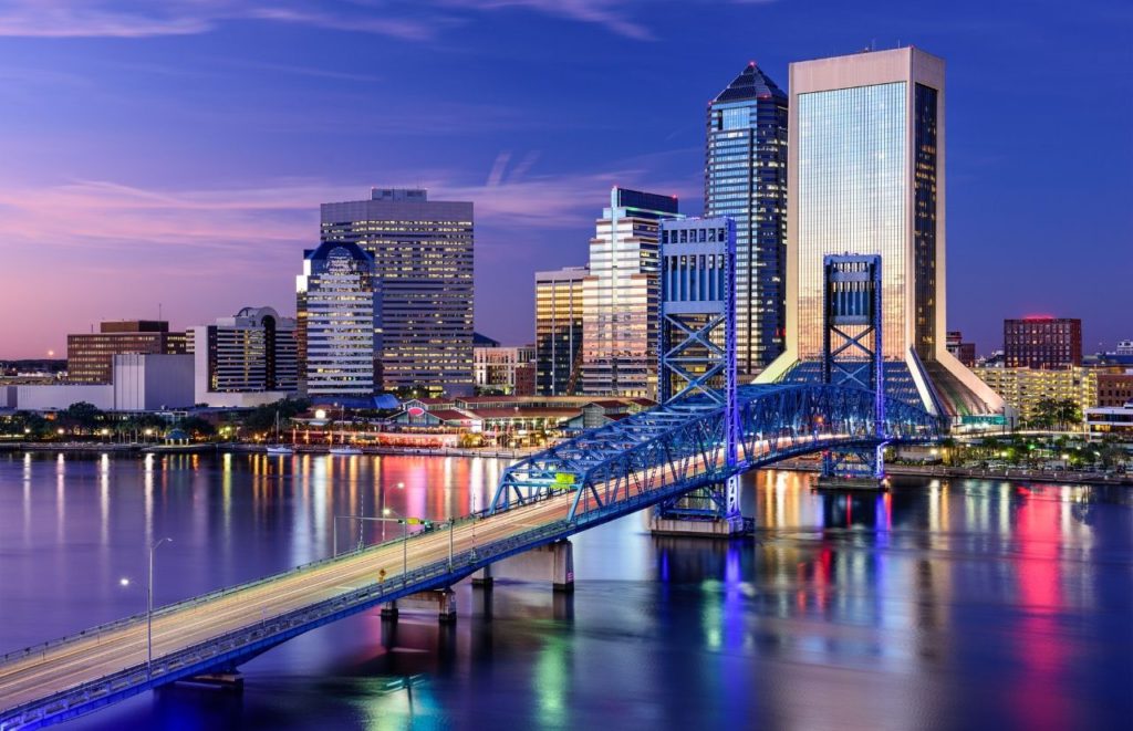 A nighttime view of the skyline and one of the bridges entering Jacksonville, Florida. Keep reading for more places to take a perfect day trip from Orlando, Florida. 