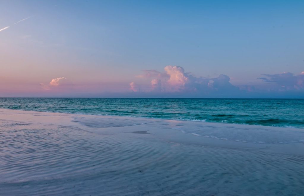 Neptune Beach Florida with beautiful colors of blue and shades of pink. Keep reading to find out all you need to know for your next day trip from Gainesville.
