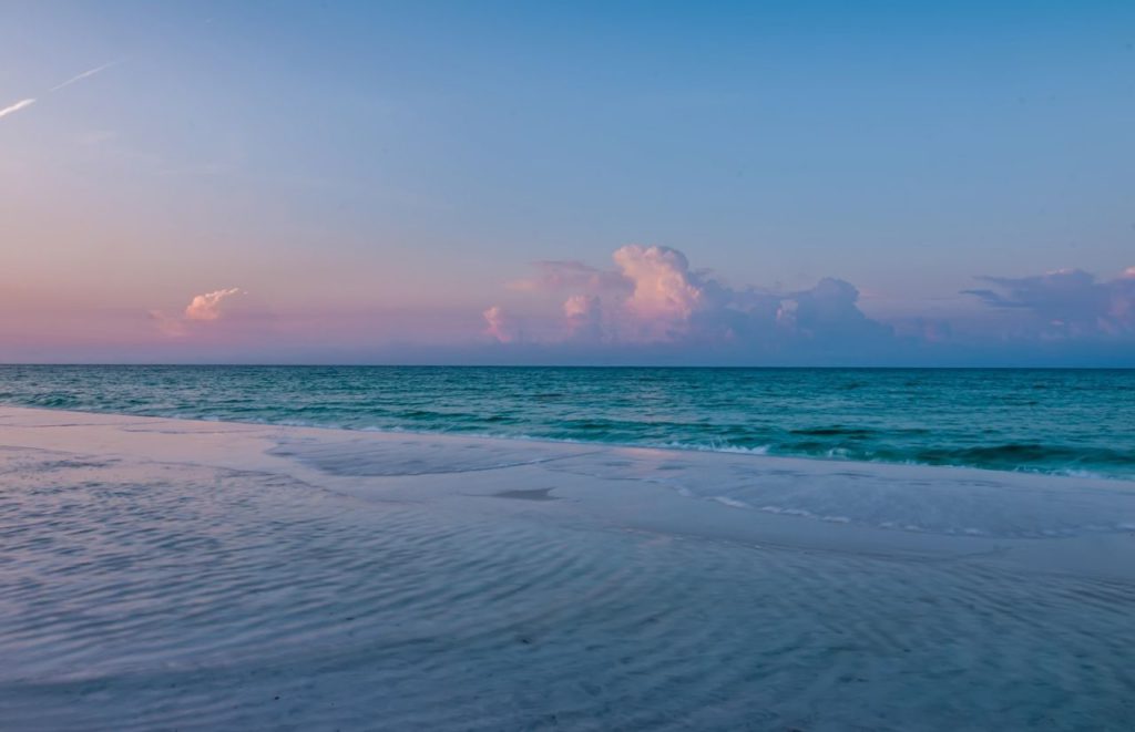 A view of waves crashing on the beach at Neptune Beach, Florida. Keep reading for more places to take a perfect day trip from Orlando, Florida. 