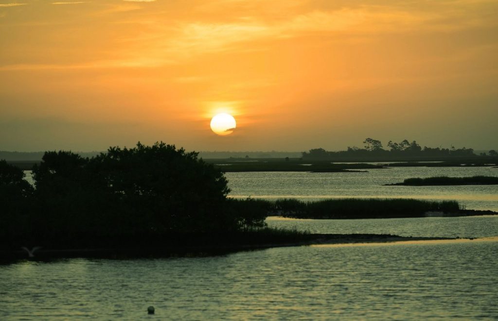 Tavares Florida sunrise over Lake Harris. Keep reading to get the best days trips from The Villages, Florida.