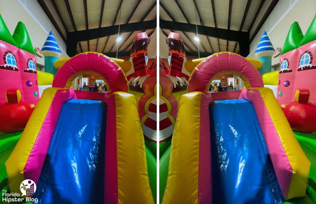 Jungle Zone indoor Park in Tavares Florida Inflatable pink, blue and yellow slide. Keep reading to learn more of the best things to do in Orlando with toddlers and a baby.