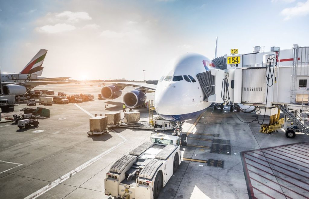 Large airplane prepping for flight. Keep reading to learn all you need to know about taking both a backpack and a carry-on on a plane. 