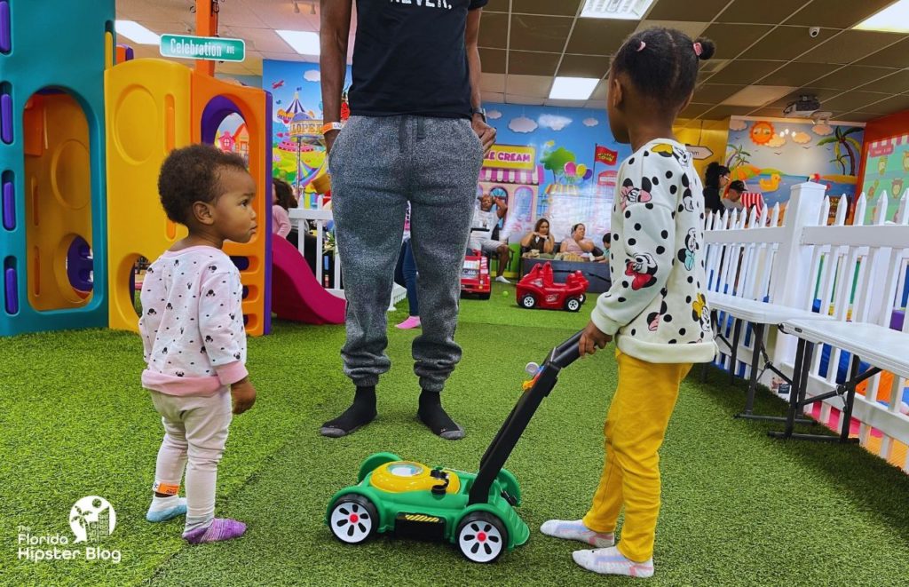 Little black girls playing at My Little Town in Orlando Florida. Keep reading to learn more about Orlando birthday celebrations.