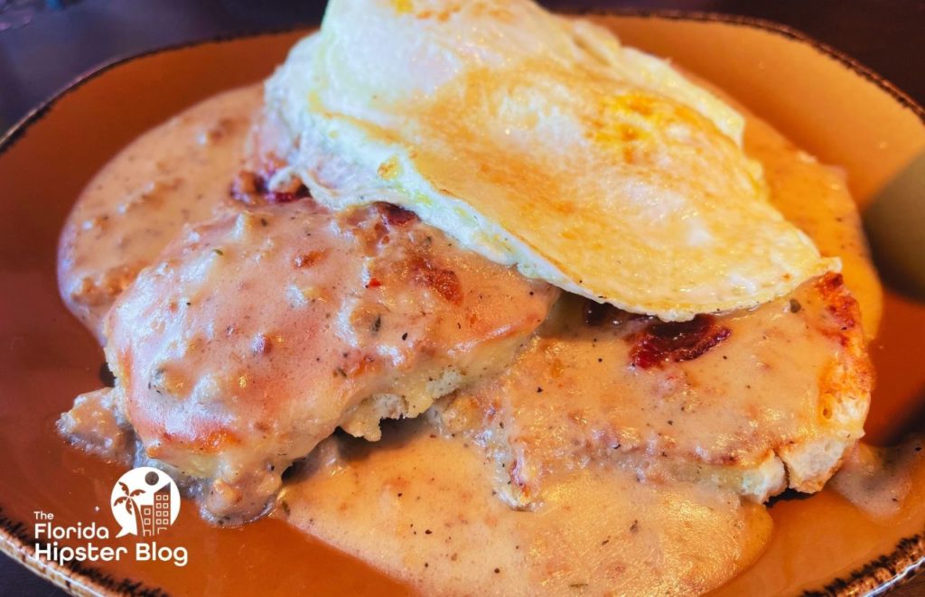 Wine Bar George in Disney Springs Orlando Brunch Smothered Biscuit with Egg. Keep reading to find out where to go for the best brunch in Orlando. 