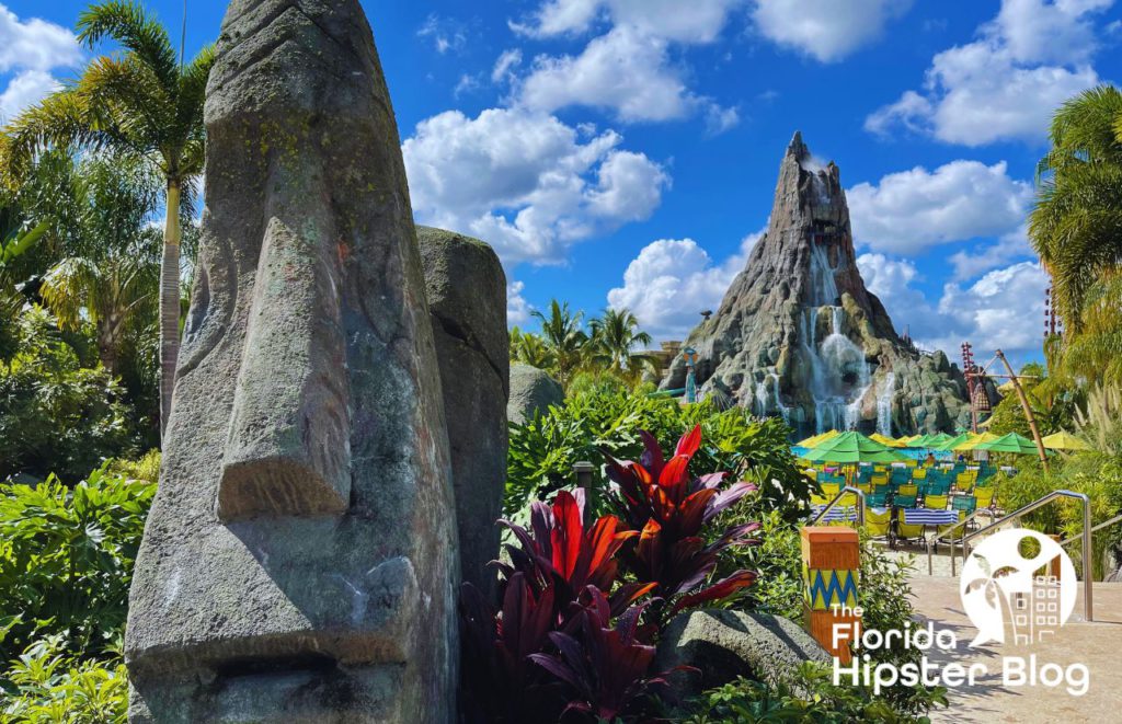 Volcano Bay Water Park at Universal with flowing water on volcano in the background and rock face statues. Keep reading to find out the best things to do in Orlando for teens. 